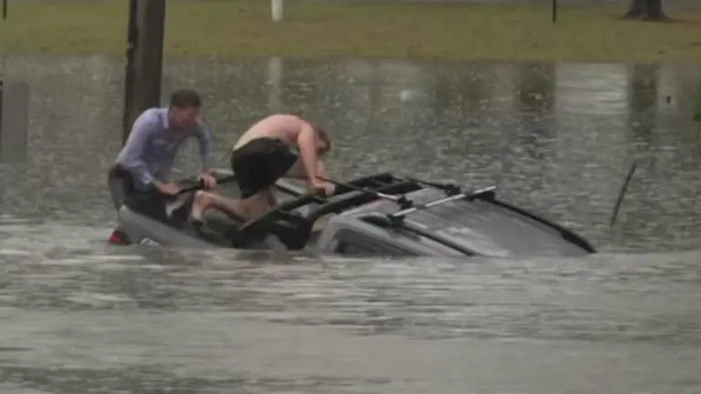 ‘It’s terrifying’: ABC reporter rescues driver from sinking ute in north Brisbane floodwaters