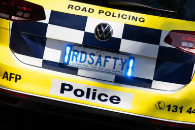 Woman refused bail after allegedly driving at two pedestrians beside road