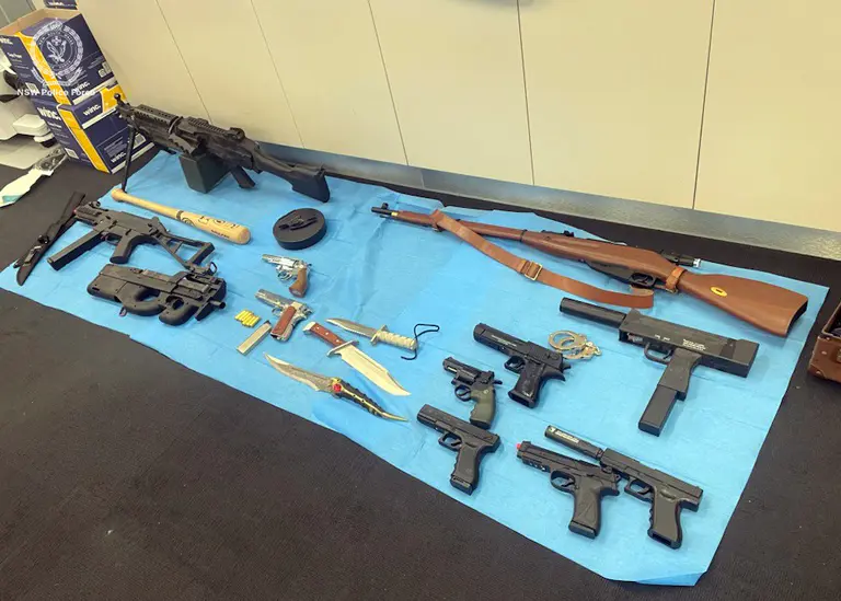 Facing 25 charges over weapons stash