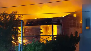 Manhunt after elderly woman rescued from inferno