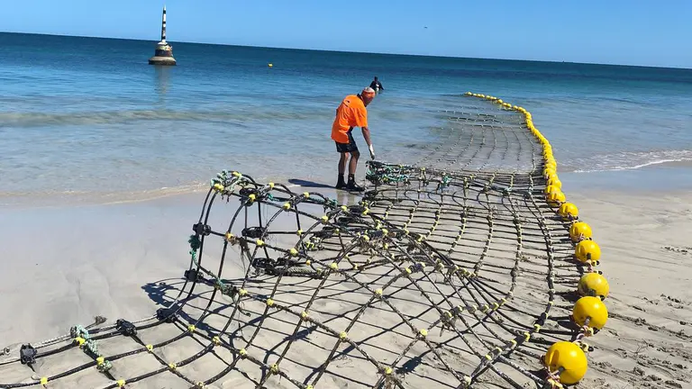 Cottesloe Beach shark barrier back in the ocean at critical time for local swimmers