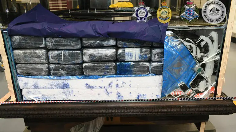 Trio charged after 120kg of cocaine found in cabinets